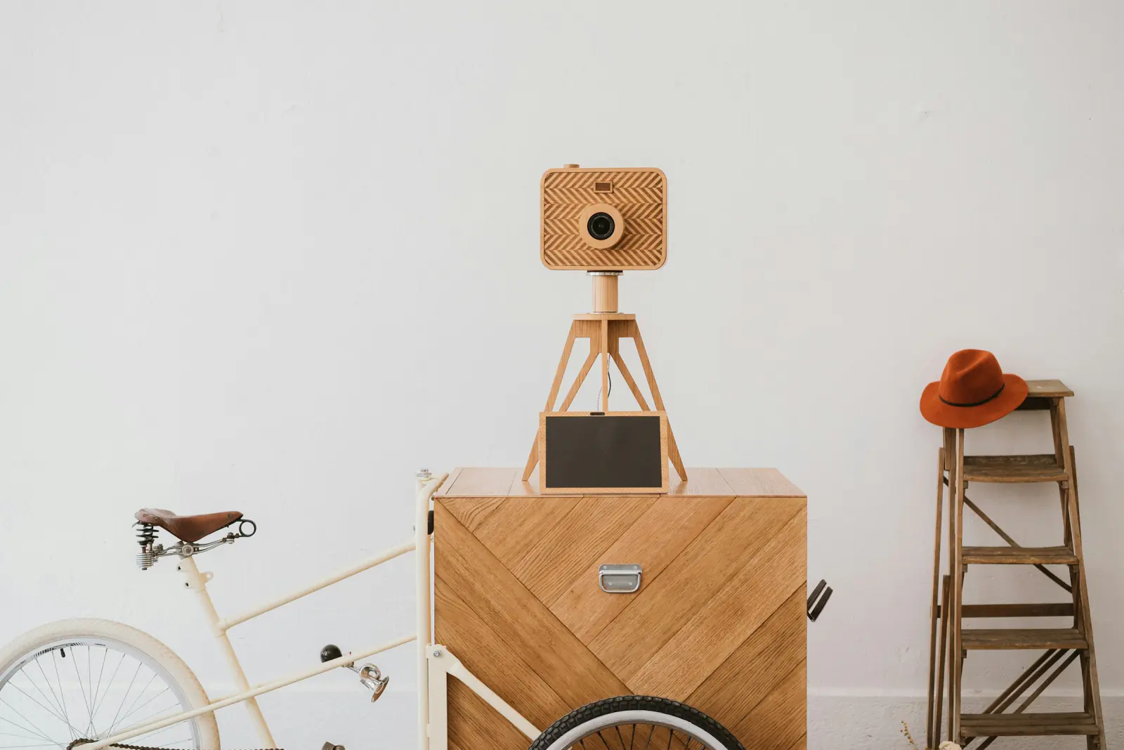 Self-built photo booth: a camera on a small wooden tripod mounted on a wooden cart