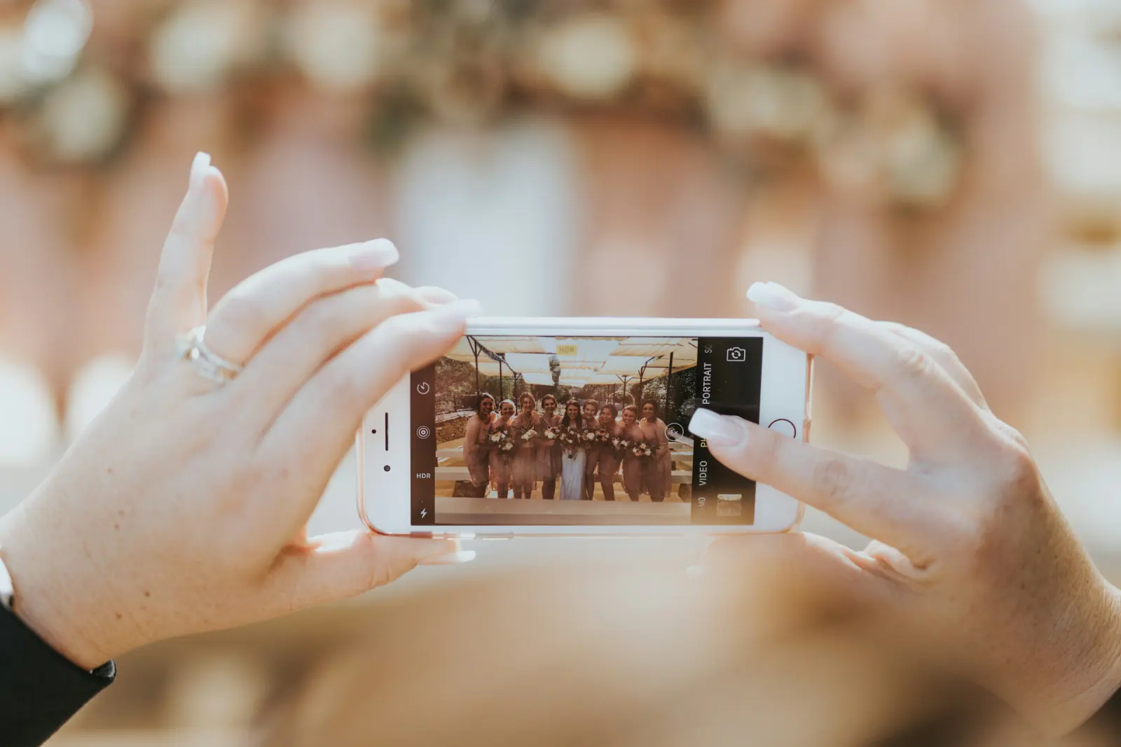 Guest holding up a smartphone to photograph a group of people