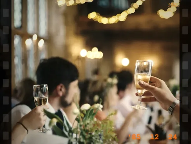 Friends raising a toast in the warm, grainy Vintage Film look, shaped for a template window